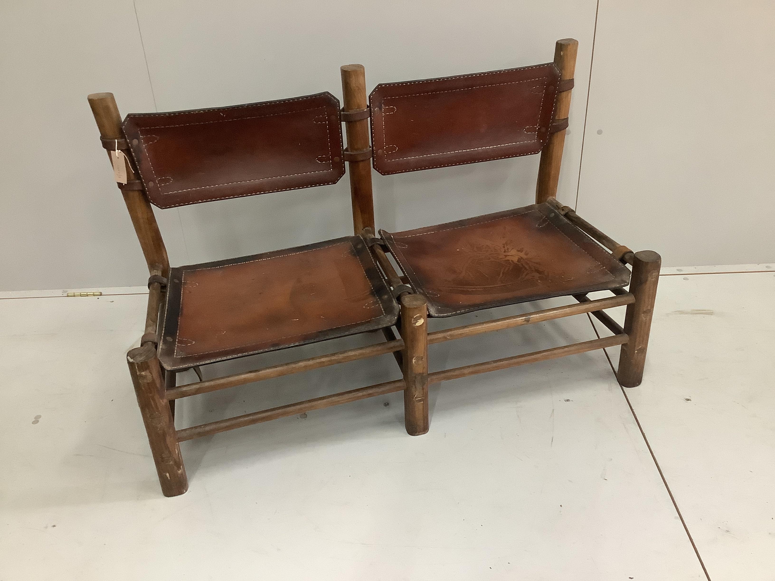 A Native American hardwood and leather double chair seat, width 116cm, depth 48cm, height 73cm
